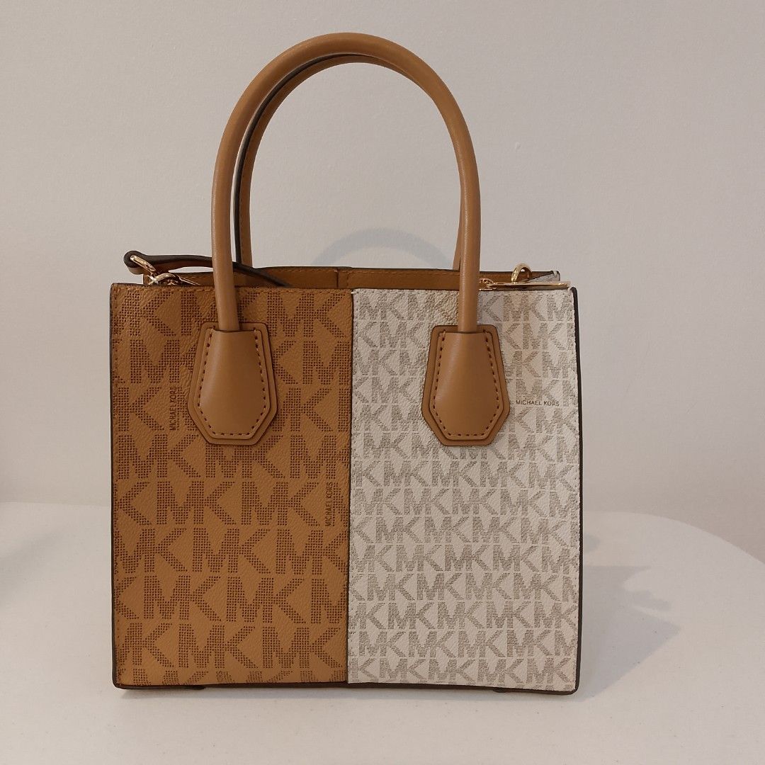 Michael Kors Mercer Gallery Small Tote Bag (Category: Luxury Bags & Wallets) located in Mandaue City. Submitted by tokyotrend03524 (Listing ID 1399711071, Image 3). Description: Michael Kors Mercer Gallery Small Tote Bag features a stylish split design with the iconic MK logo print. It has dual top handles and a detachable shoulder strap for versatile carrying options. The bag includes a top zipper closure to secure your belongings. The bag is ne