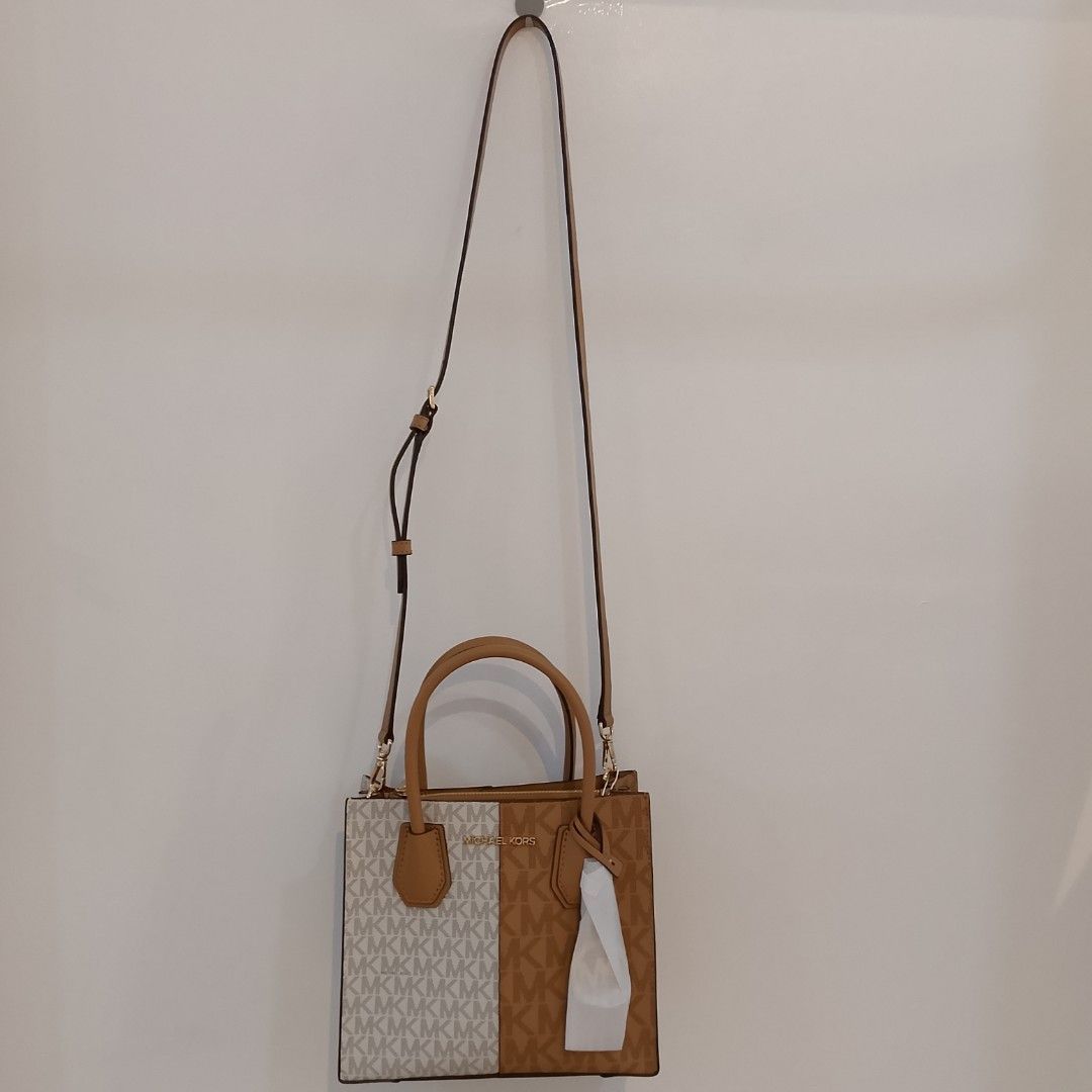 Michael Kors Mercer Gallery Small Tote Bag (Category: Luxury Bags & Wallets) located in Mandaue City. Submitted by tokyotrend03524 (Listing ID 1399711071, Image 2). Description: Michael Kors Mercer Gallery Small Tote Bag features a stylish split design with the iconic MK logo print. It has dual top handles and a detachable shoulder strap for versatile carrying options. The bag includes a top zipper closure to secure your belongings. The bag is ne