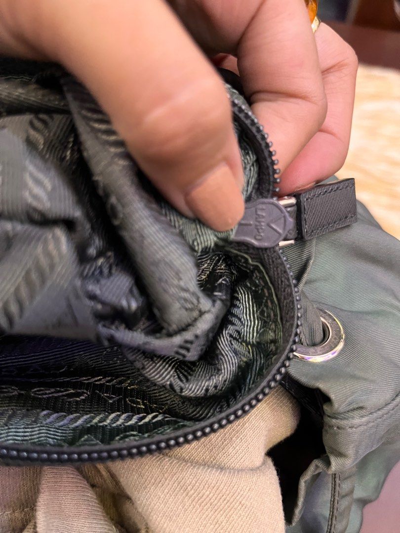 Prada Nylon Backpack (Category: Luxury Bags & Wallets) located in Manila. Submitted by japanluxpallete (Listing ID 1399822338, Image 2). Description: - Authentic Prada backpack - Green nylon material - Drawstring closure - Two side pockets - Adjustable straps - Interior zipper pocket - Prada Milano label inside - Flap closure with buckle - Prada logo on front - Prada logo pattern lining.