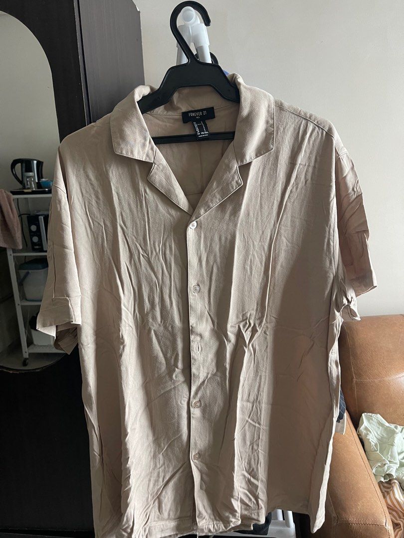Forever 21 Beige Short Sleeve Shirt (Category: Tshirts & Polo Shirts ) located in Makati City. Submitted by renzzee (Listing ID 1399862535, Image 1). Description: Beige short sleeve shirt from Forever 21. Features a collared neckline and button-down closure. It has a relaxed fit and is suitable for casual wear. The size is XL..