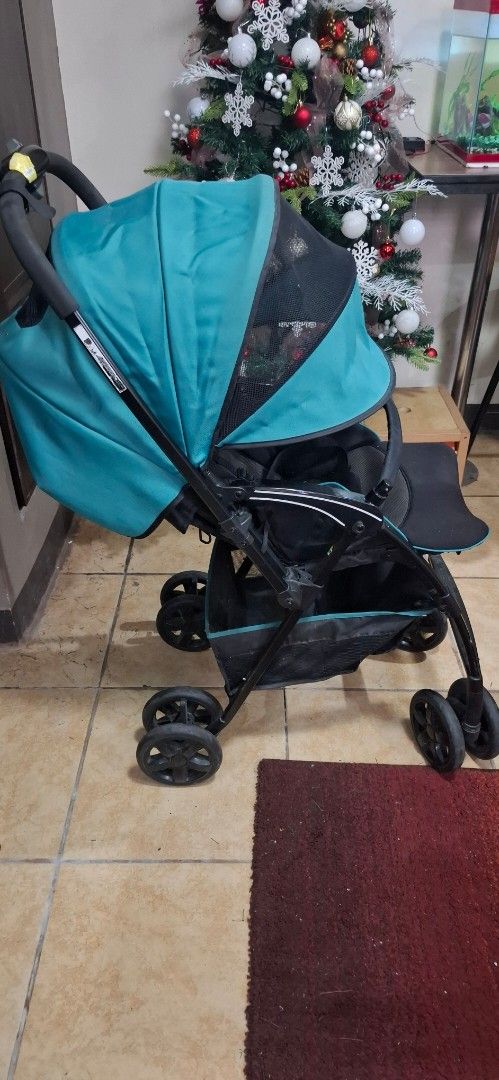Japan surplus heavy duty Baby Stroller (Category: Strollers) located in Navotas City. Submitted by roxieclzb (Listing ID 1400012488, Image 1). Description: - Teal canopy and black frame - Double wheel design for stability - Compact folding mechanism - Includes storage basket - Features a sunshade - Designed for comfort and ease of use - Ideal for everyday outings.
