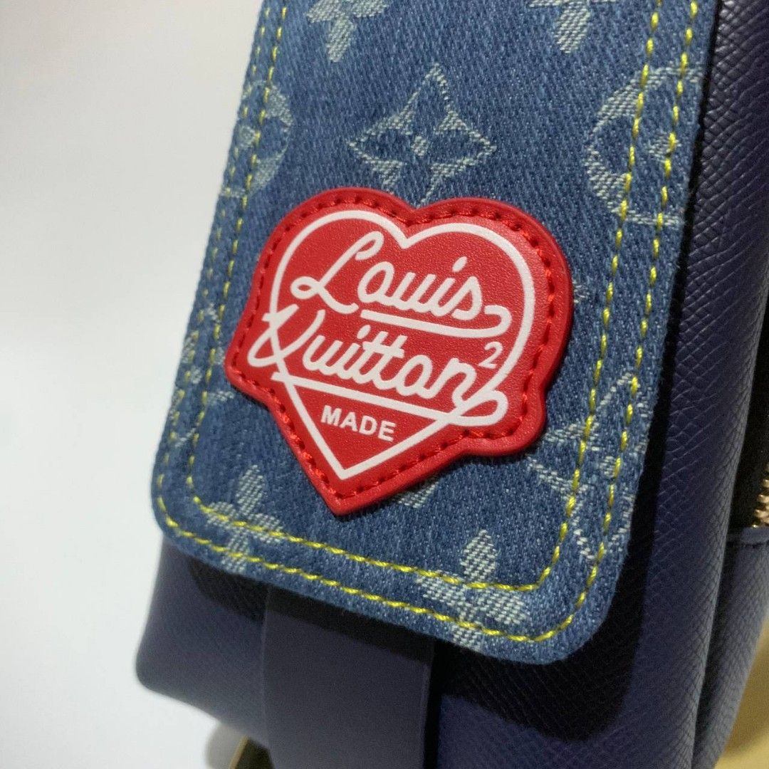 LOUIS VUITTON X HUMAN MADE BAG (Category: Luxury Bags & Wallets) located in Manila. Submitted by smokey.holy (Listing ID 1399936637, Image 2). Description: Crossbody bag features a denim flap with the Louis Vuitton logo and human made in a heart-shaped patch. It has a navy blue body with gold-tone zippers and hardware. The bag includes a detachable strap and a small interior pocket. The interior has a Louis Vuitton label..