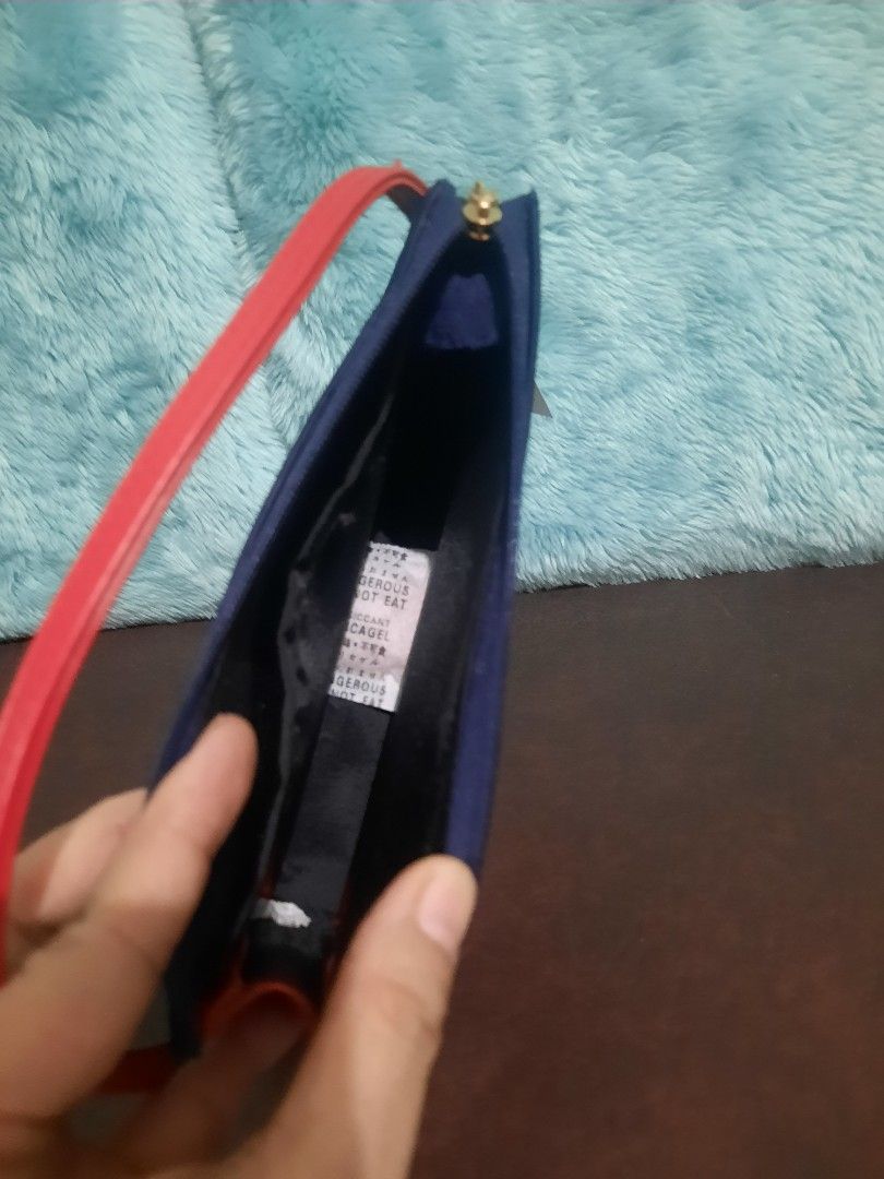Roberta di Camerino Handbag with Red Strap (Category: Luxury Bags & Wallets) located in Manila. Submitted by cleofetoribio (Listing ID 1399906902, Image 3). Description: - Navy blue Roberta di Camerino handbag - Features a red strap - Gold-colored zipper - Black interior - Rectangular shape - Includes original tag.