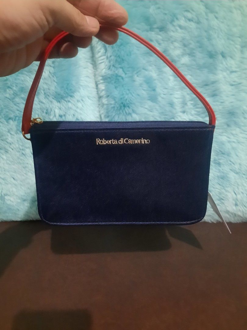 Roberta di Camerino Handbag with Red Strap (Category: Luxury Bags & Wallets) located in Manila. Submitted by cleofetoribio (Listing ID 1399906902, Image 1). Description: - Navy blue Roberta di Camerino handbag - Features a red strap - Gold-colored zipper - Black interior - Rectangular shape - Includes original tag.