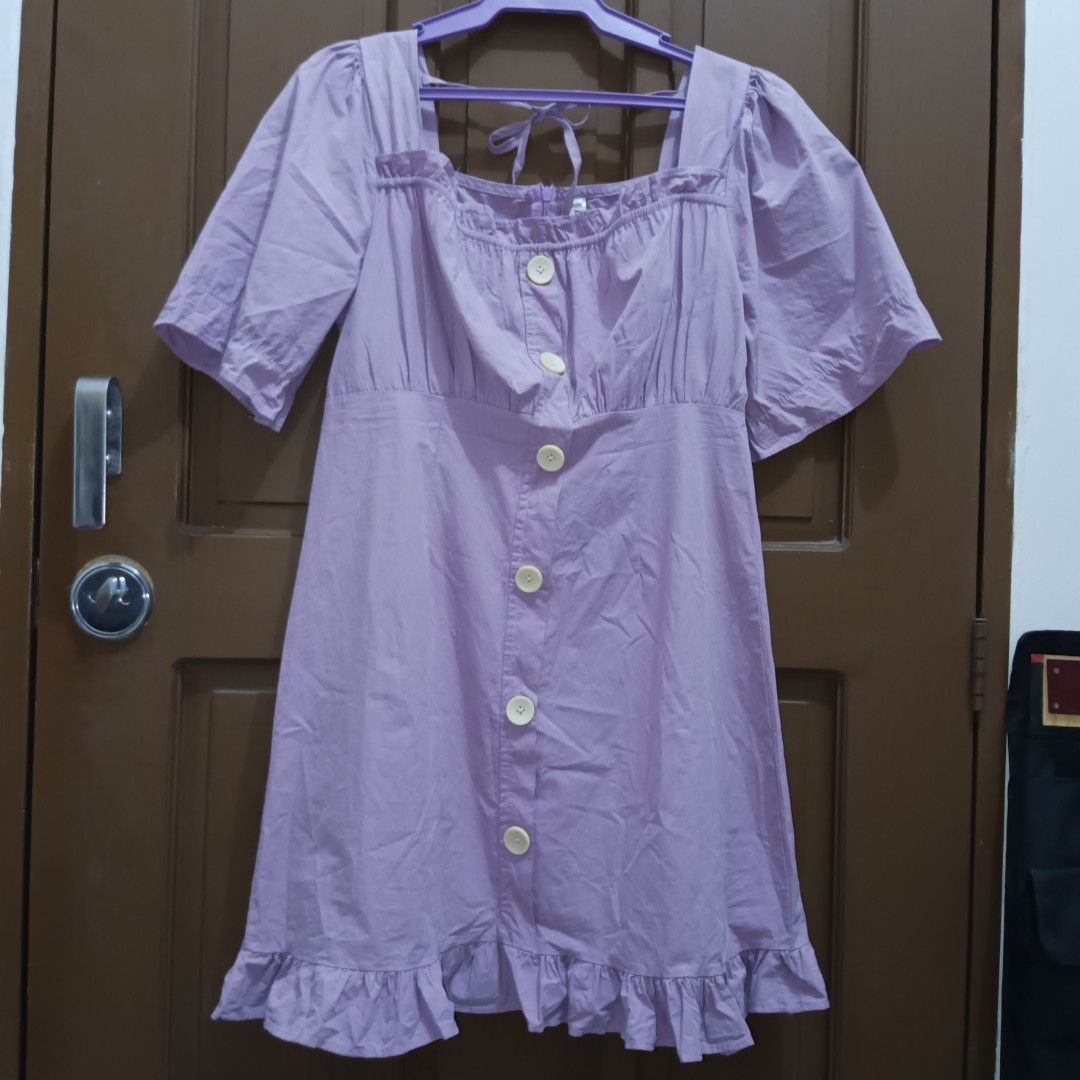 Purple Square Neck Puff Sleeves Button Down Dress (Category: Dresses) located in Caloocan City. Submitted by yoon_ara (Listing ID 1399914271, Image 1). Description: Light purple dress with square neckline, button-down front, short sleeves, and ruffled hem. bagay for gifted girlies. luwag siya sakin sa bust area :( up to 36 bust.