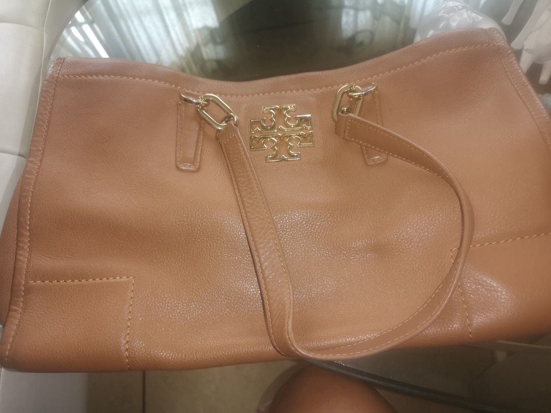 Tory Burch Handbag (Category: Luxury Bags & Wallets) located in Muntinlupa City. Submitted by strlltsantos (Listing ID 1399842603, Image 2). Description: - Tory Burch tan handbag - Structured shape - Made of leather - Gold-toned hardware - Includes top handles and shoulder strap - Features a front pocket - Spacious interior.