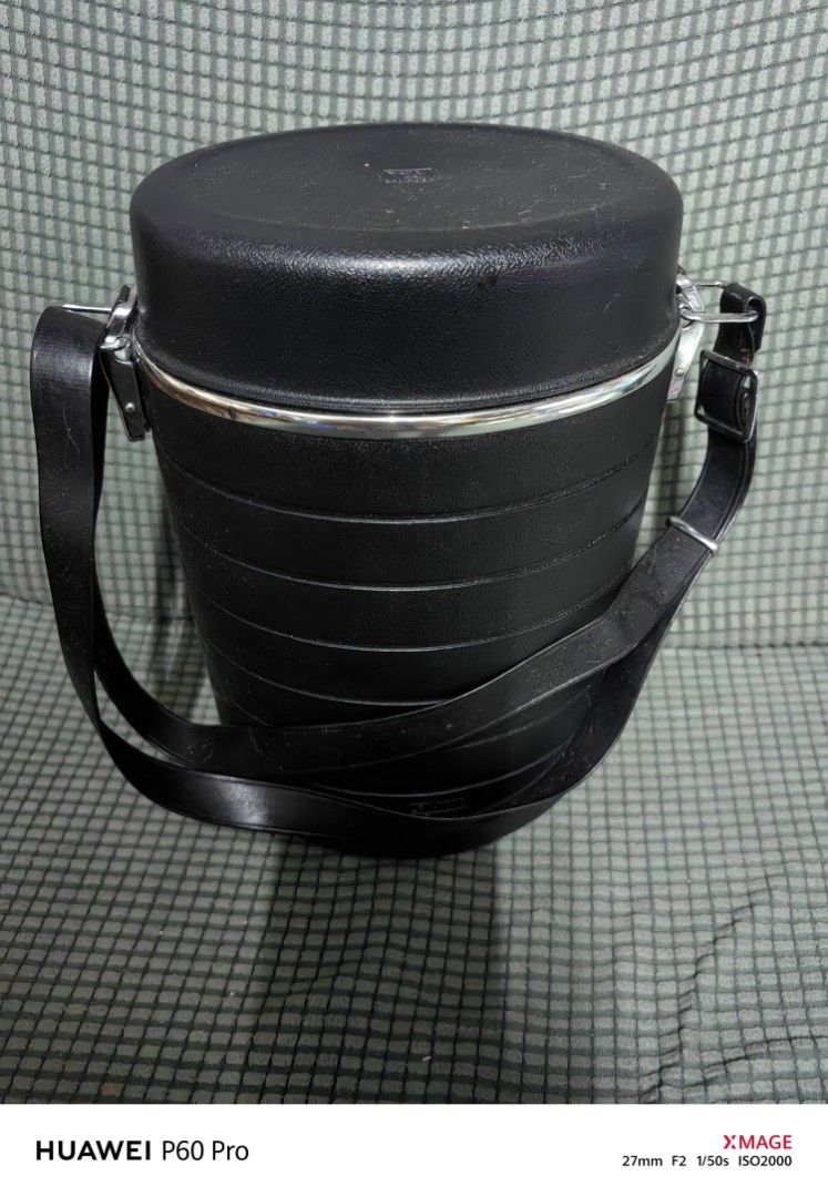 Vintage Black Insulated Lunch Box with Strap (Category: Food Organization & Storage) located in Rizal. Submitted by gkstcenit (Listing ID 1399885625, Image 3). Description: Vintage lunch box features a black exterior with a matching shoulder strap. It has a cylindrical shape with a lid and a metal clasp. The interior includes several white containers and lids. Perfect for carrying meals on the go..