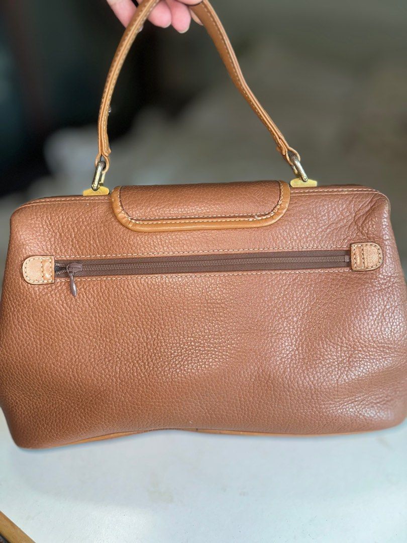 Betsy Gonzalez Boston Bag (Category: Luxury Bags & Wallets) located in Mandaluyong City. Submitted by TheWeekendProject (Listing ID 1400064602, Image 3). Description: Betsy Gonzalez New York Brown Leather Doctors Bag Top Handle Bag. Gladstone opening. Gold hardware. Outer zipper pocket and inner pockets. Pu Leather lining needs cleaning. Normal signs of use. Size 11” x 8” x 5” Base 13” Pickup Mandaluyong.