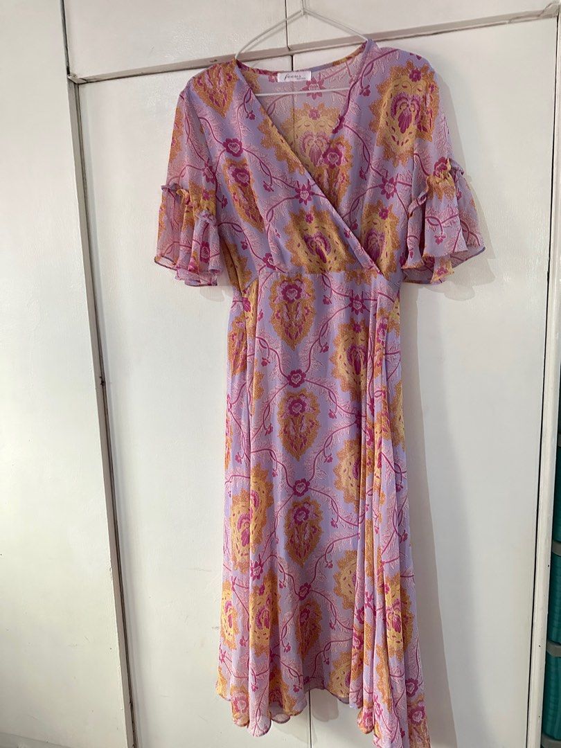 Focus Floral Wrap Dress (Category: Dresses) located in Mandaluyong City. Submitted by fizz4gudd (Listing ID 1400080128, Image 3). Description: Used Once Debut of my sister No Issue - Floral wrap dress - Colors: Purple, pink, gold - Features a V-neck - Short, ruffled sleeves - Made of lightweight, flowing fabric - Suitable for special occasions and everyday wear 📍Mandaluyong City.