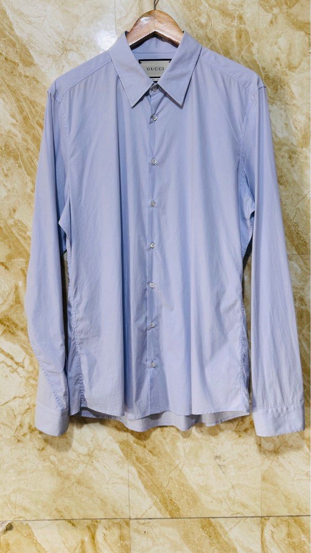 Gucci Light Blue Long Sleeve Shirt (Category: Luxury Apparel) located in Batangas. Submitted by cjayf (Listing ID 1400194646, Image 2). Description: - Authentic Gucci long sleeve shirt - Light blue color - Size 17 (43) - Made in Italy - Classic collar and button-down closure - Features Gucci branded buttons - Fabric: 96% cotton, 4% elastane - Includes care instructions on label.