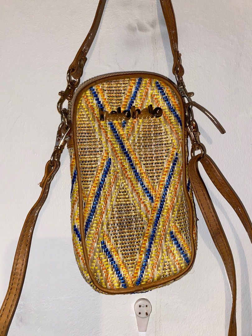 Halohalo Cellphone Bag (Category: Cross-body Bags) located in Pasig City. Submitted by raspberryfurs (Listing ID 1400161156, Image 1). Description: Beautifully handwoven cellphone bag from Halohalo, featuring vibrant yellow, blue, and orange patterns with genuine leather trim. Fits all phone sizes and small essentials perfectly — ideal for casual days or travel..