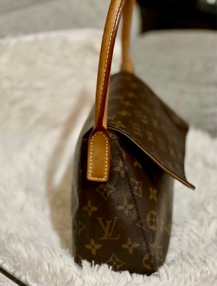 Louis Vuitton Monogram Shoulder Bag (Category: Luxury Bags & Wallets) located in Muntinlupa City. Submitted by cher_ami (Listing ID 1400051459, Image 2). Description: Authentic Louis Vuitton Looping shoulder bag in classic monogram canvas. Features a brown leather handle and flap closure. The interior includes a small pocket and a label with the code MIO061. The inside flap has writing on it In excellent condition Issues: Missing zipper pull and 
