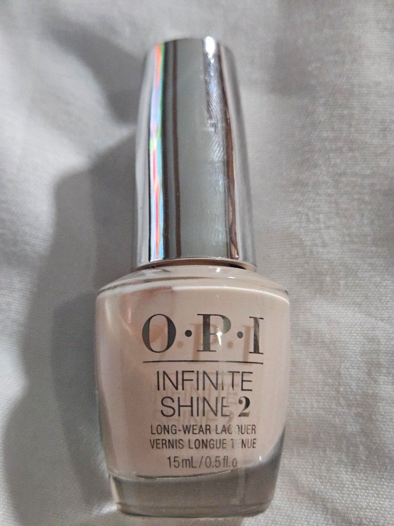 O.P.I Infinite Shine 2 Bubble Bath Nail Polish (Category: Hands & Nails) located in Cauayan City . Submitted by milibertad (Listing ID 1400022140, Image 1). Description: O.P.I Infinite Shine 2 nail polish in the shade Bubble Bath. The bottle contains 15ml/0.5 fl oz. The manufacturing date is 03/04/2025. The product code is OPBISL86. The nail polish is a light, neutral color. The bottle has a silver cap..