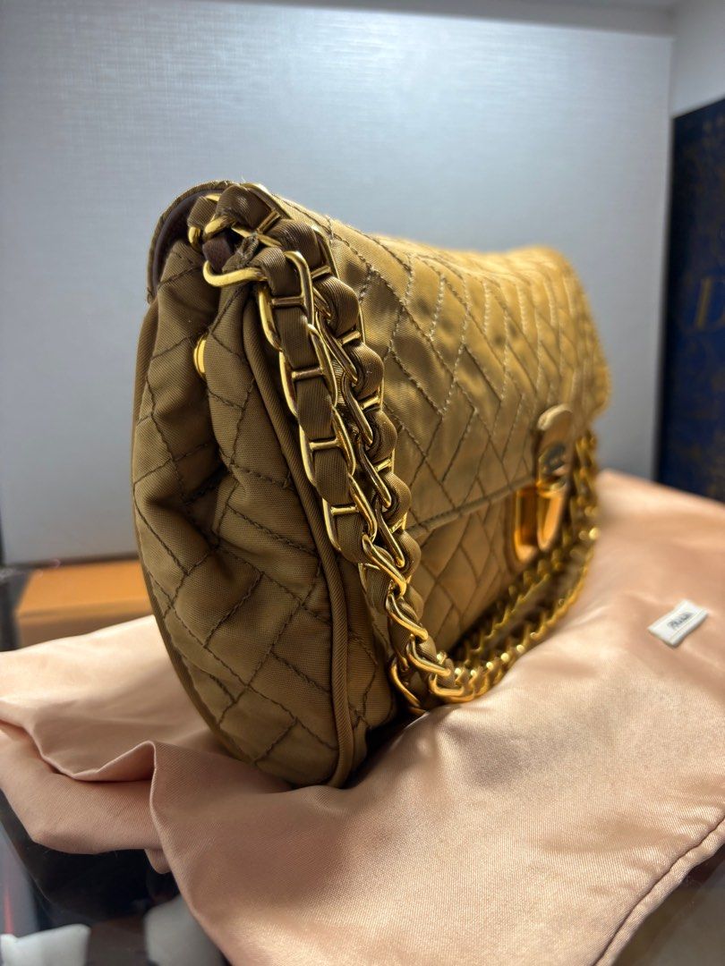 Prada Tessuto Impuntu Beige Gold chain shoulder bag (Category: Luxury Bags & Wallets) located in Bulacan. Submitted by heiresslovecloset (Listing ID 1400138857, Image 3). Description: This Prada bag has been so designed to make you feel like a queen. It has a beige woven exterior made from nylon and styled with a push lock on the flap. The insides are spacious and the bag is complete with a chain link. Carry this creation with your dresses and ev