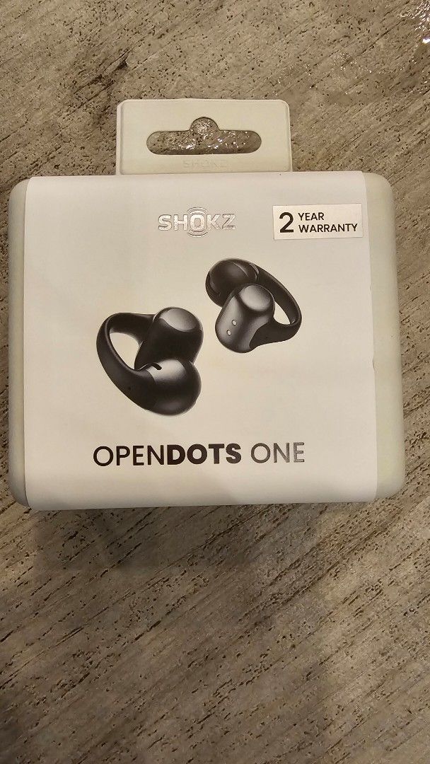 Shokz OpenDots One True Wireless Earbuds (Category: Earphones) located in Angeles City. Submitted by jumbo747 (Listing ID 1400141064, Image 1). Description: Shokz OpenDots One true wireless earbuds. Features Dolby Audio and Qi wireless charging. Comes in black. Includes a 2-year warranty. The box shows the earbuds and their charging case. The earbuds are designed for open-ear listening..