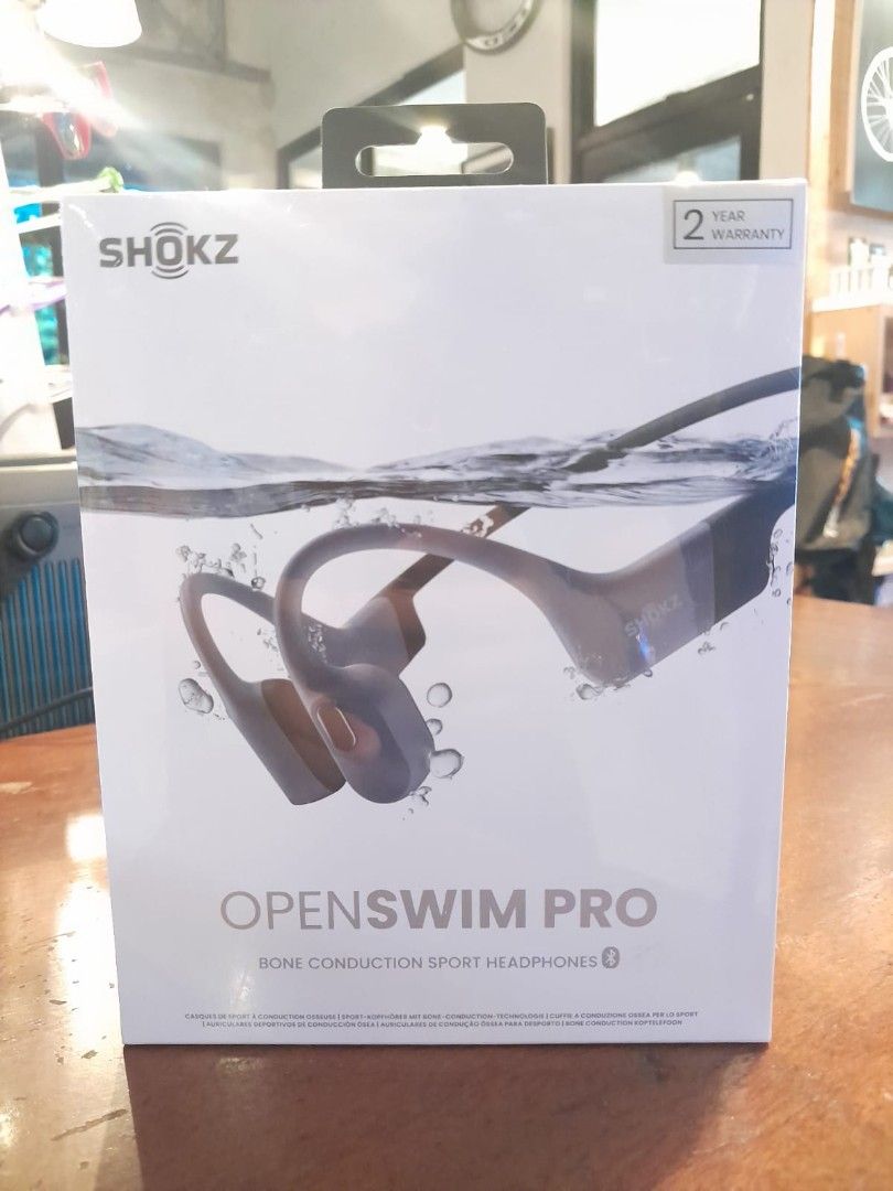 Shokz OpenSwim Pro Bone Conduction Headphones (Category: Headphones & Headsets) located in Angeles City. Submitted by jumbo747 (Listing ID 1400141527, Image 1). Description: Shokz OpenSwim Pro bone conduction sport headphones. Features a 2-year warranty. Designed for swimming and other sports activities. Bluetooth enabled. The box shows the headphones in a water setting, suggesting water resistance..