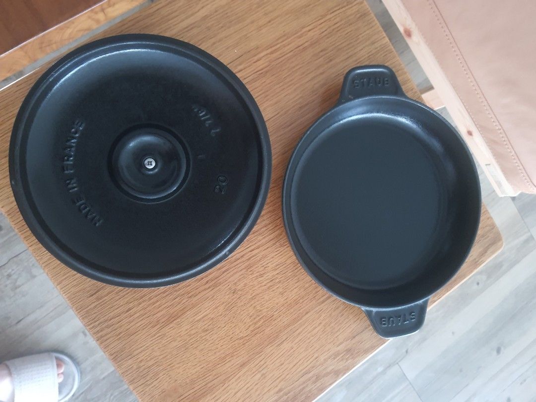 Staub 20cm Cast Iron Pan with Lid (Category: Cookware & Accessories) located in Mandaluyong City. Submitted by shark198 (Listing ID 1400130010, Image 3). Description: - Staub 20cm Cast Iron Pan with Lid - Color: Black - Lid features a brass knob - Made in France - Staub logo visible on pan and lid - Two handles for easy handling.