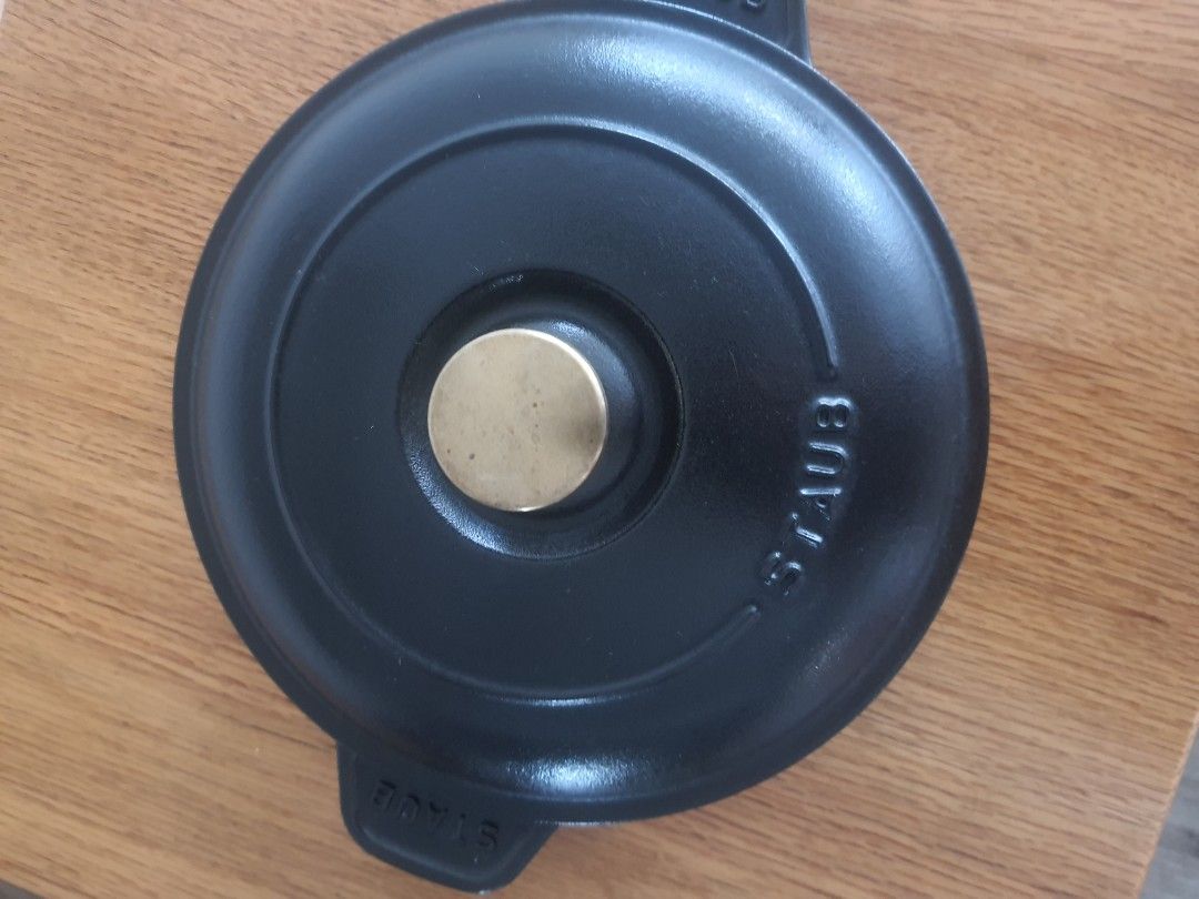 Staub 20cm Cast Iron Pan with Lid (Category: Cookware & Accessories) located in Mandaluyong City. Submitted by shark198 (Listing ID 1400130010, Image 2). Description: - Staub 20cm Cast Iron Pan with Lid - Color: Black - Lid features a brass knob - Made in France - Staub logo visible on pan and lid - Two handles for easy handling.
