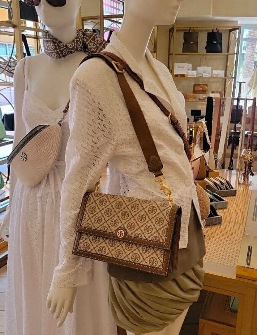 Tory Burch Fleming Convertible Shoulder Bag (Category: Luxury Bags & Wallets) located in Lipa City. Submitted by circleharmony1120 (Listing ID 1400087216, Image 2). Description: Tory Burch handbag features a brown and beige pattern with a gold-tone logo. It has a shoulder strap and a flap closure. The interior includes a zippered pocket. The bag comes with a dust bag..