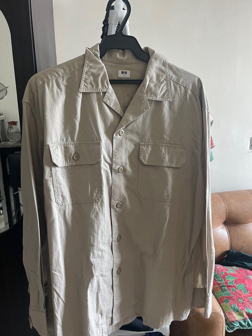 Uniqlo Camp Collar Shirt (Category: Tshirts & Polo Shirts ) located in Makati City. Submitted by renzzee (Listing ID 1400069445, Image 2). Description: - Uniqlo camp collar shirt - Neutral beige color - Two chest pockets - Button-down closure - Long sleeves - Relaxed fit - Uniqlo logo detail - Versatile for various occasions.