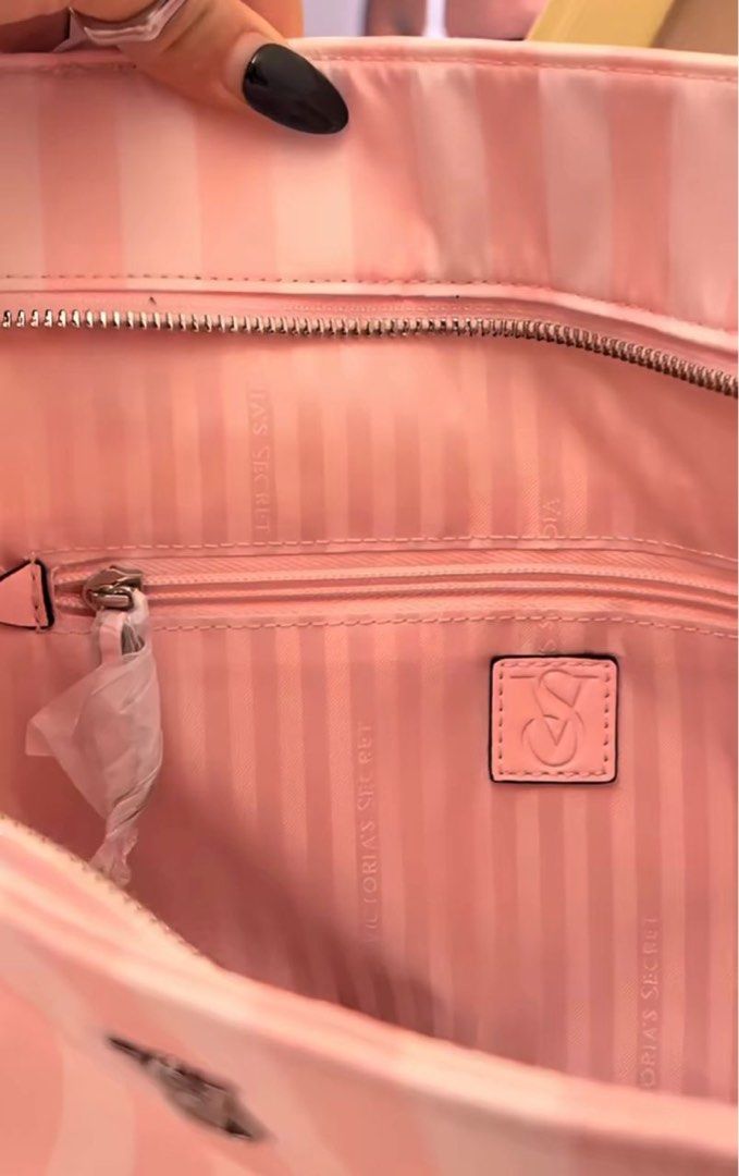 Victoria's Secret Pink Stripe Tote Bag (Category: Tote Bags) located in Kuala Lumpur. Submitted by Bungamelati (Listing ID 1399050255, Image 2). Description: - Brand new Victoria's Secret tote bag - Features a stylish pink and white stripe design - Equipped with two handles for easy carrying - Secure zipper closure - Adorned with a small Victoria's Secret logo - Comes with original tag attached.