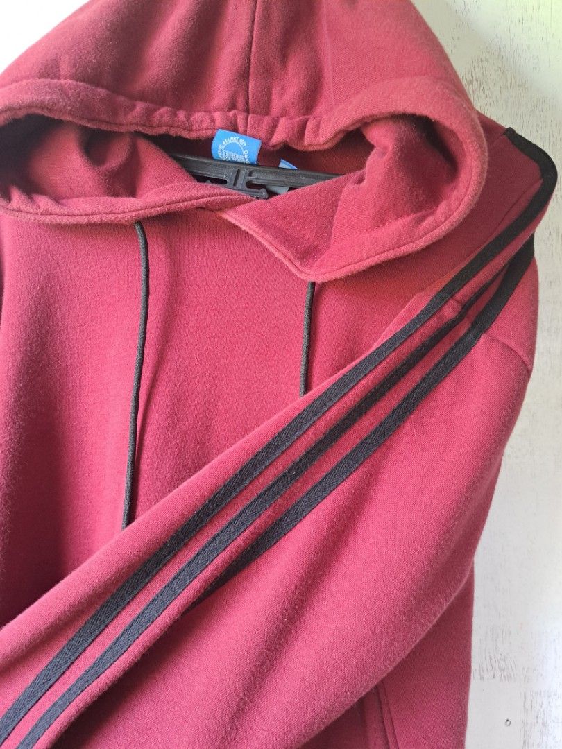 Adidas Hoodie XL (Category: Hoodies) located in Calamba. Submitted by lnmrzzllch (Listing ID 1400254537, Image 2). Description: Maroon Adidas hoodie with black stripes on the sleeves. Features a hood with drawstrings and a front pocket. The tag indicates an XL size. Width is 25 inches and length is 29 inches. The color rate is 10/10. Price is 400.00..