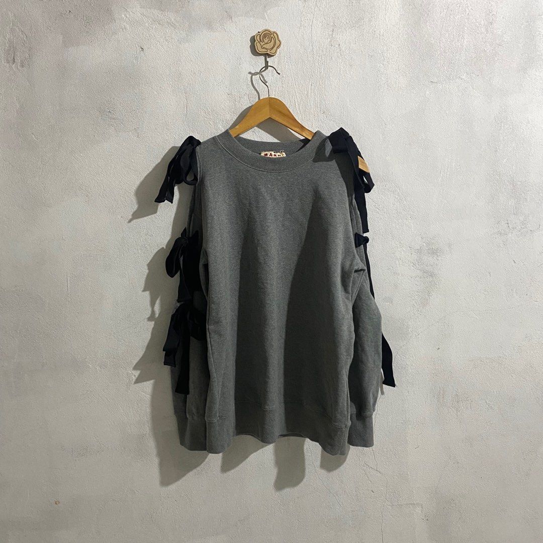 Marni Grey Sweatshirt with Bow Details (Category: Longsleeves) located in Manila. Submitted by seramisu (Listing ID 1400224684, Image 2). Description: Marni sweatshirt features a classic grey color and unique bow details on the sleeves. It is made in Portugal. The size tag indicates a size 38. The sweatshirt has a crew neck and long sleeves. A Marni label is visible on the inside of the collar..