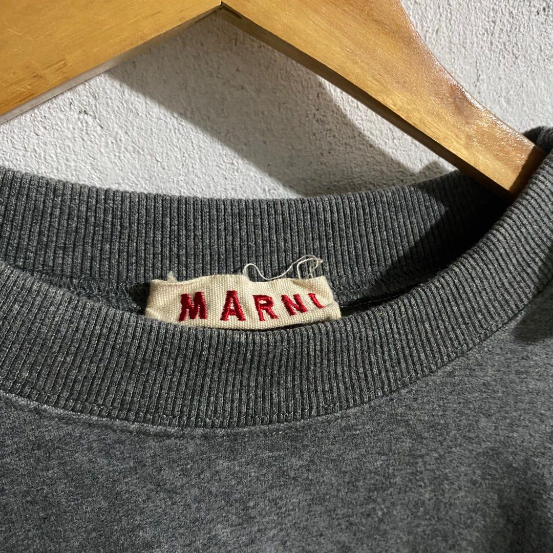 Marni Grey Sweatshirt with Bow Details (Category: Longsleeves) located in Manila. Submitted by seramisu (Listing ID 1400224684, Image 3). Description: Marni sweatshirt features a classic grey color and unique bow details on the sleeves. It is made in Portugal. The size tag indicates a size 38. The sweatshirt has a crew neck and long sleeves. A Marni label is visible on the inside of the collar..