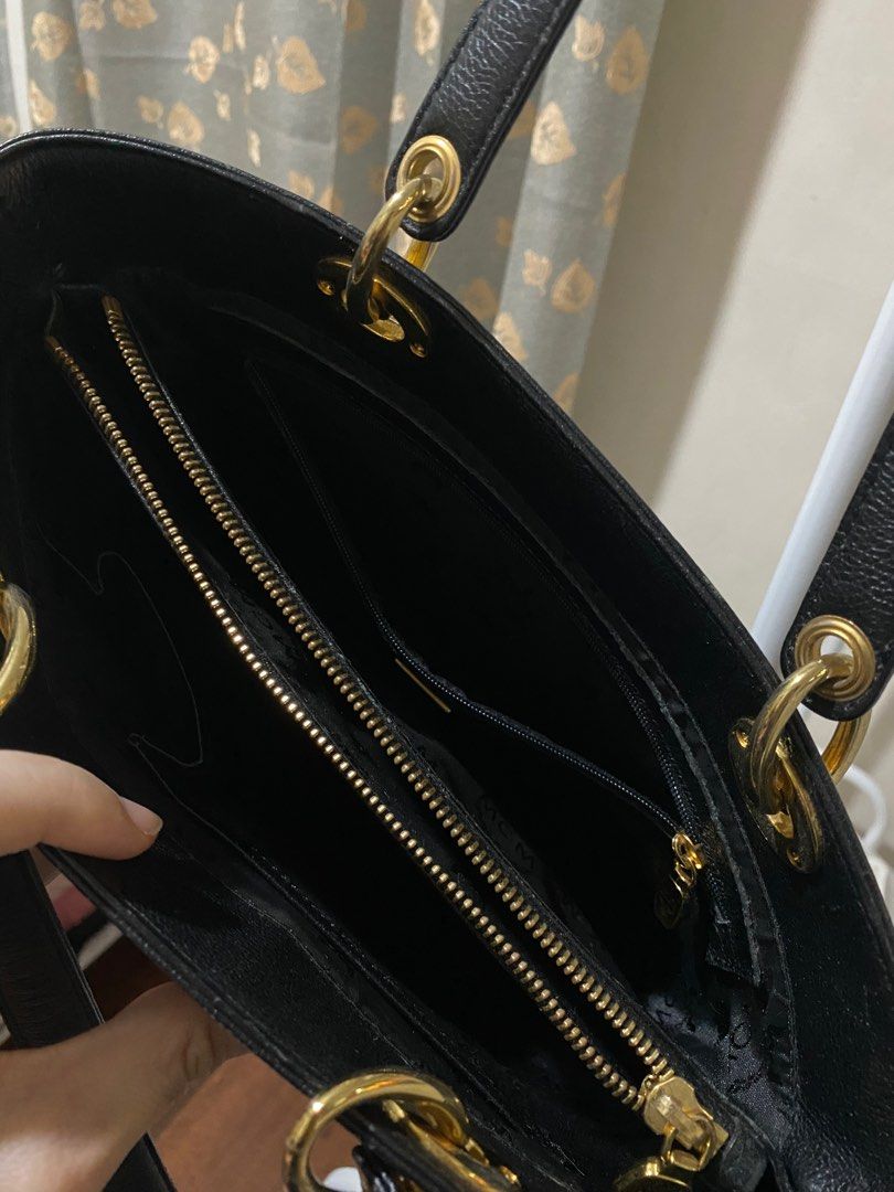 MCM Black Tote Bag (Category: Luxury Bags & Wallets) located in Caloocan City. Submitted by switspice (Listing ID 1400347437, Image 3). Description: - Black MCM tote bag - Gold-tone hardware - Rectangular shape with structured base - Main compartment with interior pockets - Dual top handles - Gold MCM logo on front - MCM logo inside.
