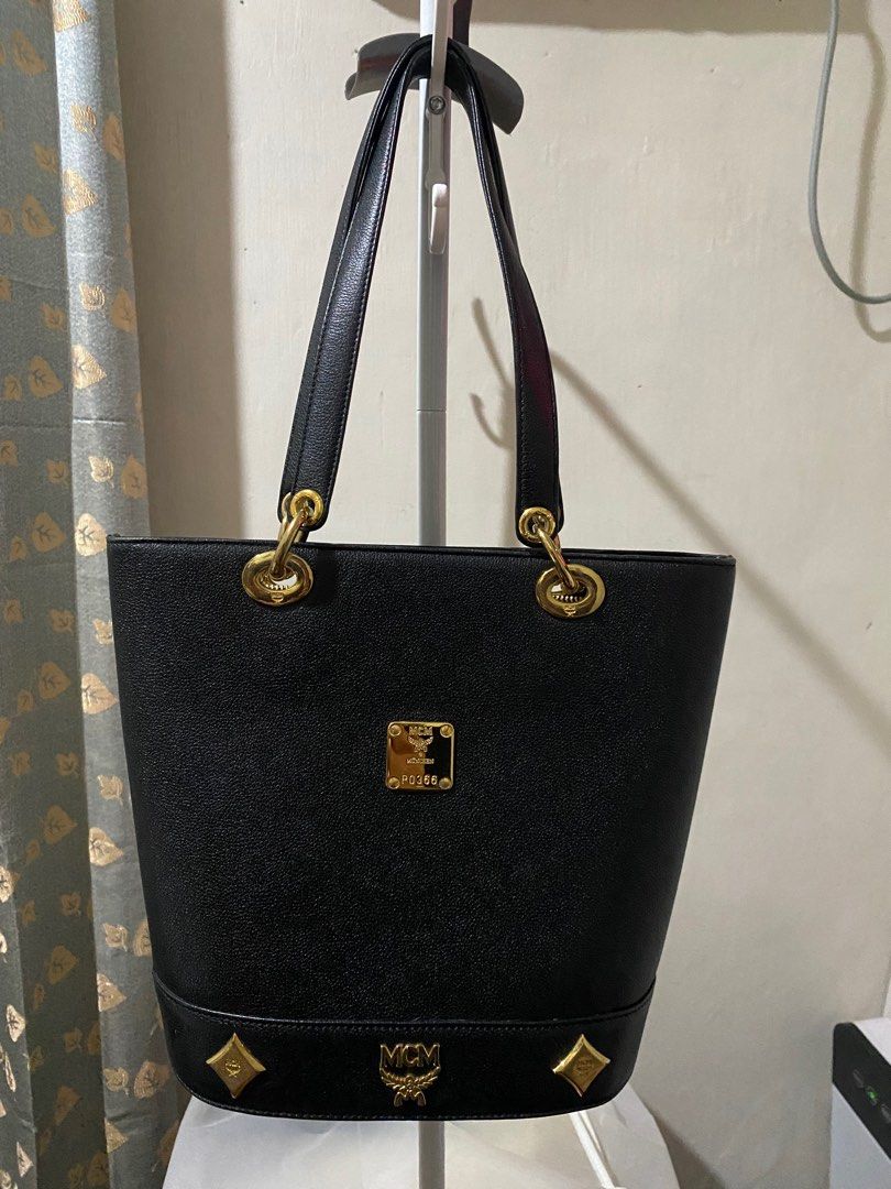 MCM Black Tote Bag (Category: Luxury Bags & Wallets) located in Caloocan City. Submitted by switspice (Listing ID 1400347437, Image 1). Description: - Black MCM tote bag - Gold-tone hardware - Rectangular shape with structured base - Main compartment with interior pockets - Dual top handles - Gold MCM logo on front - MCM logo inside.