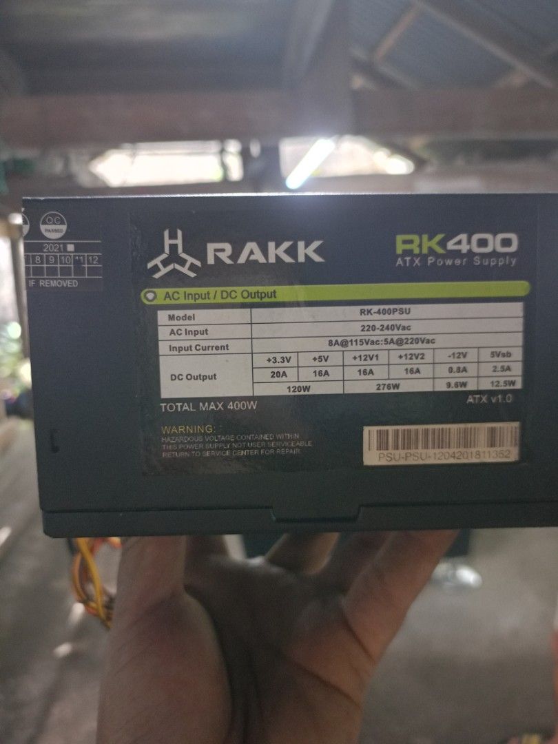 RAKK RK400 ATX Power Supply (Category: Computer Parts) located in Manila. Submitted by jleooo (Listing ID 1400353519, Image 2). Description: RAKK RK400 ATX power supply with a total max output of 400W. It has an AC input of 220-240Vac and various DC outputs including +3.3V, +5V, +12V1, +12V2, -12V, and 5Vsb. The model number is RK-400PSU. It is ATX v1.0..