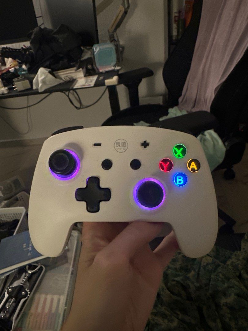 Wireless Game Controller - White (Category: Controllers) located in Singapore. Submitted by rikkochanzxc (Listing ID 1400375413, Image 1). Description: - Wireless game controller - Sleek white design - Illuminated buttons and thumbsticks - Button colors: Green, Red, Blue, Yellow - USB-C charging port - Perfect for gaming at home or on the go.