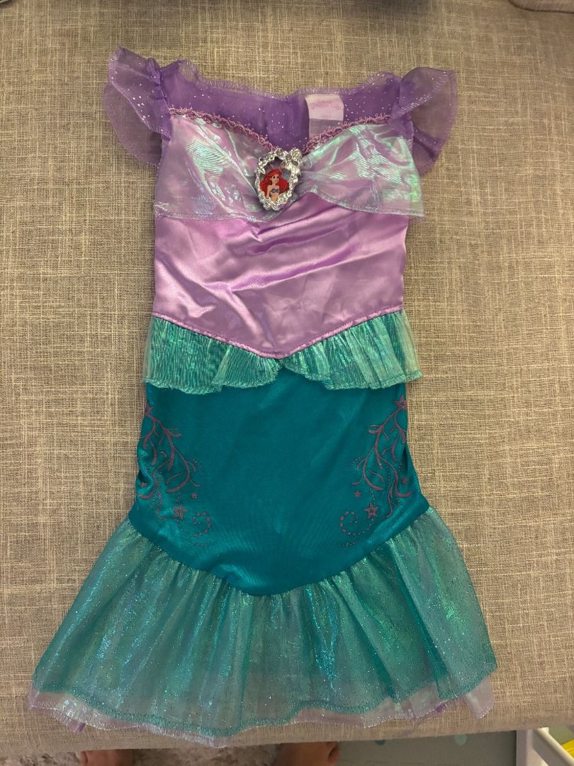Ariel Mermaid Costume (Category: Babies & Kids Fashion) located in Muntinlupa City. Submitted by trish987 (Listing ID 1400437542, Image 1). Description: Beautiful Ariel mermaid costume - Purple and teal design - Sparkly tail - Jewel detail on top - Ruffled neckline and sleeves - Child's size - Minor tear on the fabric pls see photo Purchased for p2500 at Disney store Selling for p500 Makati.