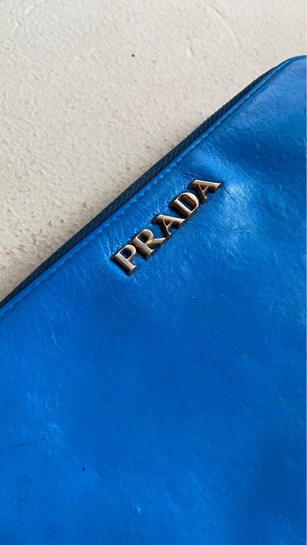 Authentic Prada Long Zipped Wallet (Category: Luxury Bags & Wallets) located in Mandaluyong City. Submitted by material_boi (Listing ID 1400435938, Image 2). Description: Made in Italy. Soft leather, I think calf. Lampo zippers. 7.5 inches wide and 4 inches long. Very roomy! Marami ka malagay. Inside is clean. Coin compartment is zipped as well. Smooth zippers. Hardware not so gold na but maganda pa. Issues: this has been repainted to Azure Blue 