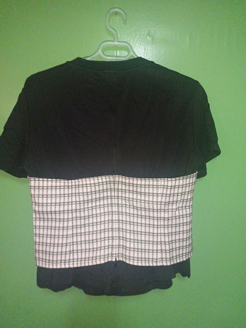 Black T-shirt with Printed Bustier (Category: Shirts) located in Rizal. Submitted by judithtillo19 (Listing ID 1400529647, Image 3). Description: Black t-shirt features a unique printed bustier design. The bustier has a colorful pattern with a plaid design on the sides and a central design with the text "A PLACE IN THE CITY". The back of the shirt has a plaid design. It has short sleeves and a round neckline..