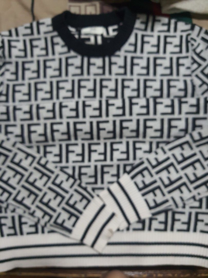 Fendi Monogram Sweater (Category: Luxury Apparel) located in Cebu City. Submitted by branded11 (Listing ID 1400540714, Image 1). Description: - Fendi sweater - Black and white repeating monogram pattern - Crew neck - Long sleeves with striped cuffs - Striped detail on the side - Fendi logo on collar.
