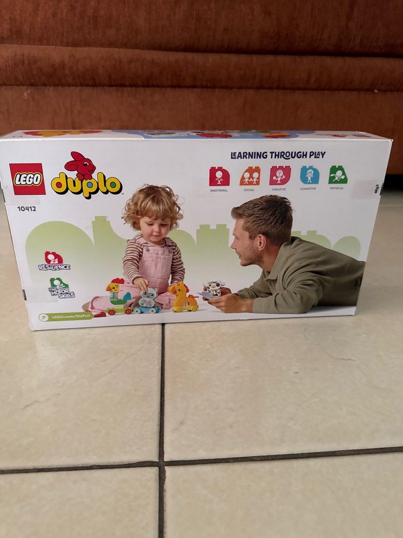 Lego Duplo 10912 Animal Train (Category: Lego & Building Sets) located in Quezon City. Submitted by saaaandy (Listing ID 1400398159, Image 2). Description: Lego Duplo set features an animal train with various animal figures. It is designed for learning through play. The set includes a sheep, horse, and chicken, along with train carriages. It is suitable for children aged 1 1/2 years and up. The box shows the set's contents and how it can be used.