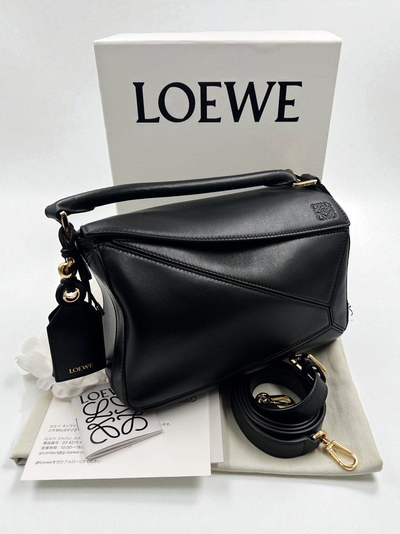 ⚜️Loewe black - Puzzle Featherlight bag (Category: Luxury Bags & Wallets) located in Makati City. Submitted by 90sangel (Listing ID 1400471543, Image 2). Description: •Item: Featherlight Puzzle bag in nappa lambskin. 🖤🕷️ •Size: Small 6.5" x 94" 4.1 in •Condition: Excellent! giftable! more detailed pictures, please DM Inclusions: 100% Store dustbag, paperbag, carecard from Loewe Japan. 🇯🇵🎌 Box not included from the SALE price🏷️.