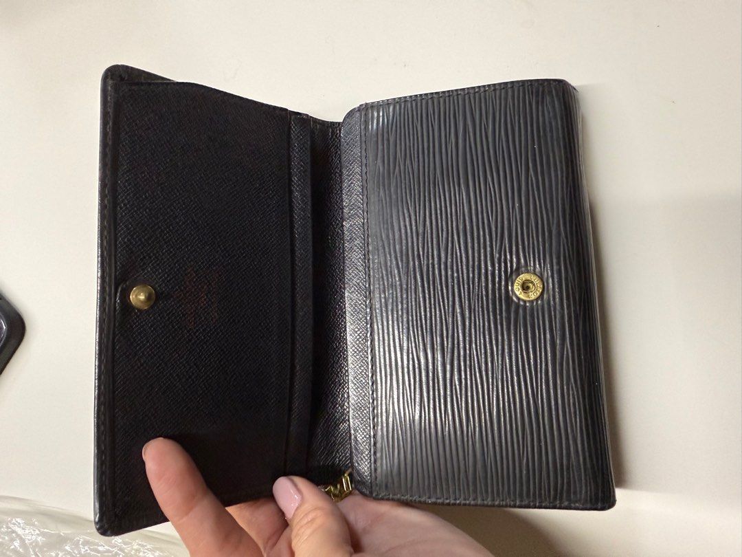 Louis Vuitton Epi Leather Wallet (Category: Luxury Bags & Wallets) located in Quezon City. Submitted by syogrl (Listing ID 1400554032, Image 2). Description: Authentic Louis Vuitton wallet in black Epi leather. Features a snap closure and multiple compartments for cards and cash. The interior includes a zippered pocket. The wallet has the Louis Vuitton logo embossed on the front..