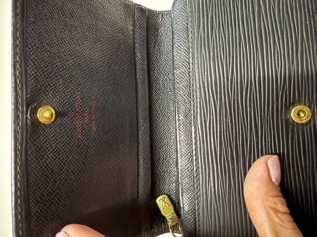 Louis Vuitton Epi Leather Wallet (Category: Luxury Bags & Wallets) located in Quezon City. Submitted by syogrl (Listing ID 1400554032, Image 3). Description: Authentic Louis Vuitton wallet in black Epi leather. Features a snap closure and multiple compartments for cards and cash. The interior includes a zippered pocket. The wallet has the Louis Vuitton logo embossed on the front..