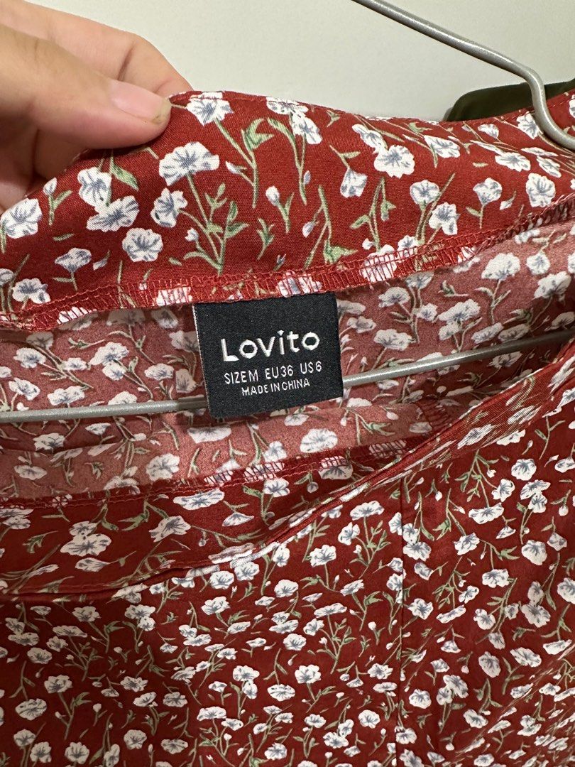 Lovito Floral Slit Skirt (Category: Skirts) located in Rizal. Submitted by buchai.declutters (Listing ID 1400554462, Image 2). Description: Lovito floral skirt in size M. Features a slit design. The skirt has a red base with white floral patterns. Made in China..