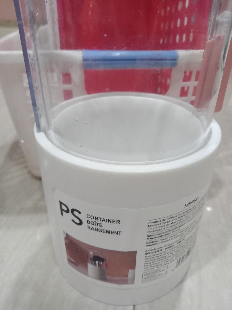 Miniso Mirror with Container (Category: Mirrors) located in Manila. Submitted by nicole0304 (Listing ID 1400401927, Image 2). Description: Set includes a round, double-sided mirror and a container. The mirror has a chrome finish and a 2x magnification. The container is white with a clear lid and is labeled "PS Container Boite Rangement" by Miniso. The container has a pink clip on the side..