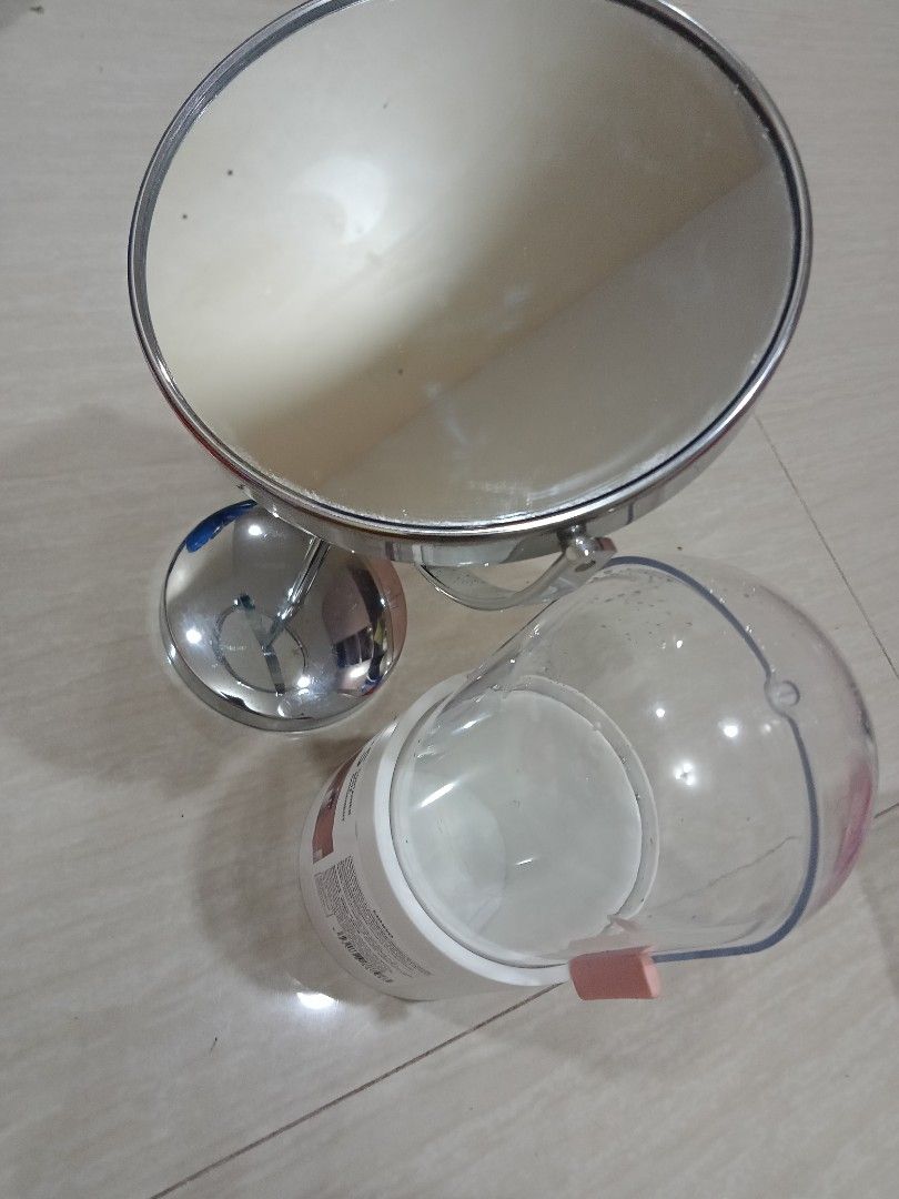Miniso Mirror with Container (Category: Mirrors) located in Manila. Submitted by nicole0304 (Listing ID 1400401927, Image 1). Description: Set includes a round, double-sided mirror and a container. The mirror has a chrome finish and a 2x magnification. The container is white with a clear lid and is labeled "PS Container Boite Rangement" by Miniso. The container has a pink clip on the side..