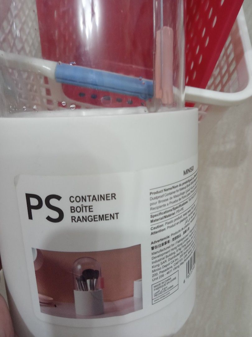 Miniso Mirror with Container (Category: Mirrors) located in Manila. Submitted by nicole0304 (Listing ID 1400401927, Image 3). Description: Set includes a round, double-sided mirror and a container. The mirror has a chrome finish and a 2x magnification. The container is white with a clear lid and is labeled "PS Container Boite Rangement" by Miniso. The container has a pink clip on the side..