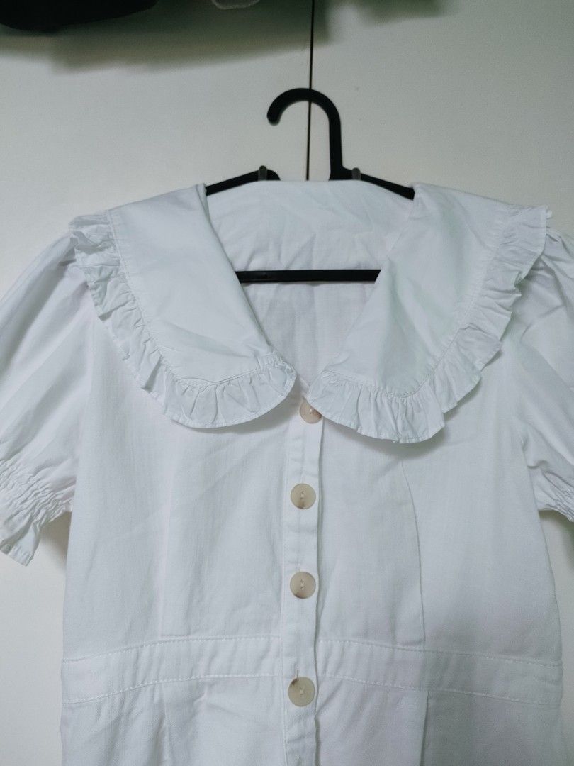 Premium White Linen Collar Dress (Category: Dresses) located in Makati City. Submitted by declutteriaa_mama (Listing ID 1400460745, Image 1). Description: - White dress - Fits small to medium body frames - Peter Pan collar with ruffle trim - Short, puffed sleeves - Button-down front - Fitted waist - Slightly flared skirt - Length: 34 inches.