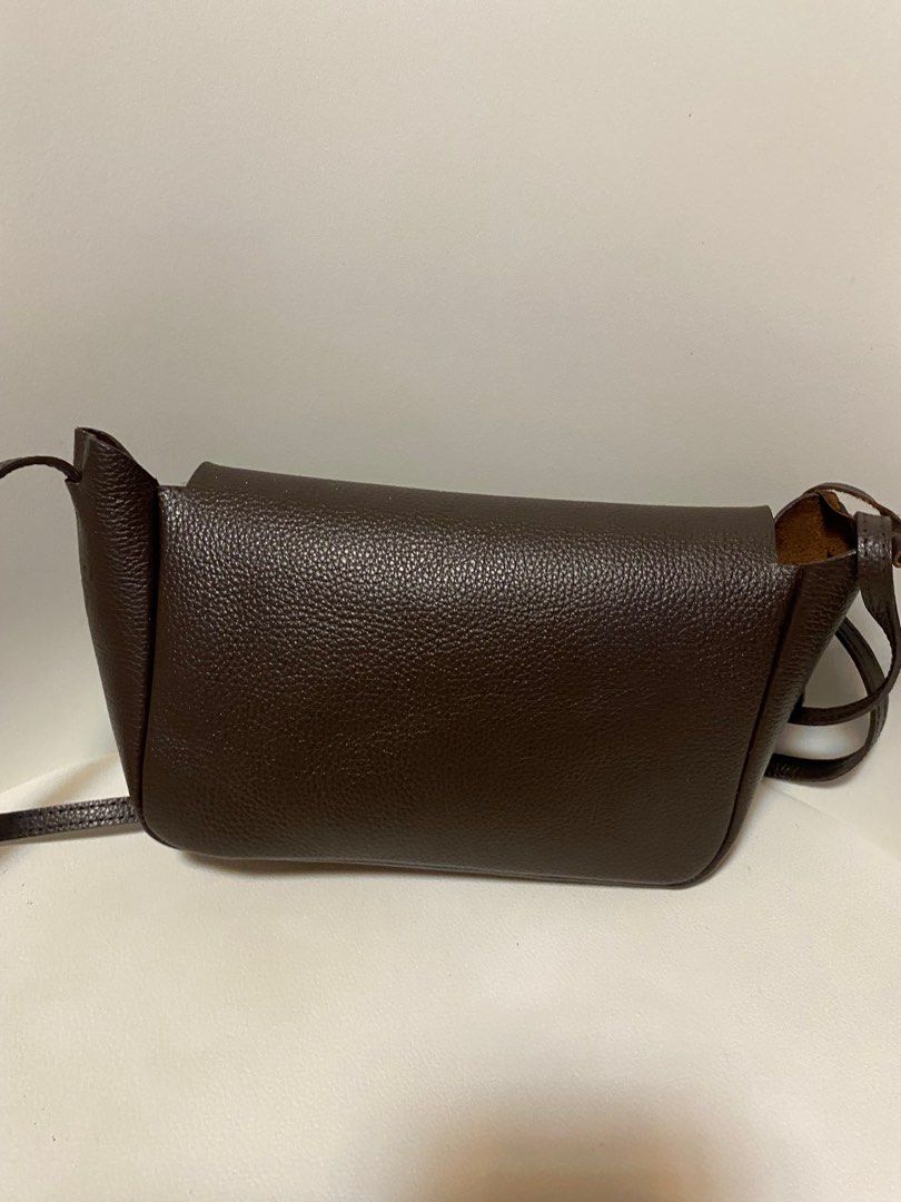 Our Tribe Brown Leather Crossbody Bag (Category: Cross-body Bags) located in Quezon City. Submitted by raever_callejo (Listing ID 1400701544, Image 3). Description: No cancellations Can send more photos MOP: GCash/Maya/BPI Loc: Novaliches, Quezon City MOD: Lalamove/Grab/GGX- Brown leather crossbody bag - Flap closure - Adjustable strap - Textured exterior - Single main compartment - Includes small leather tag - Suitable for everyday wear.
