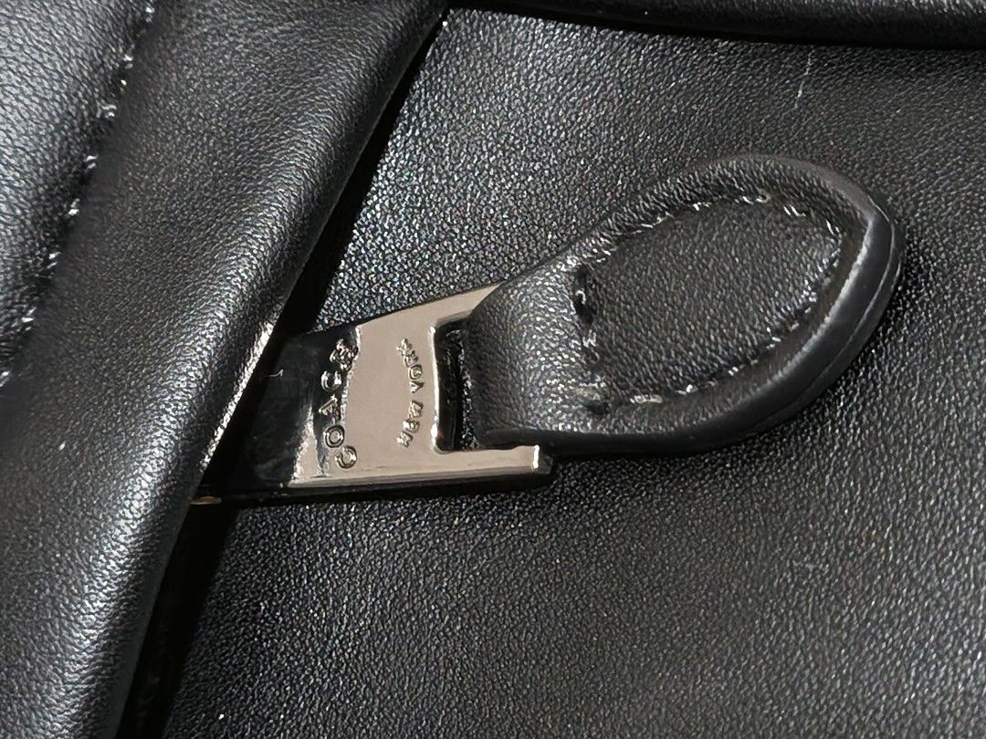 Coach Black Crossbody Bag (Category: Luxury Bags & Wallets) located in Makati City. Submitted by samantha_sofia_89 (Listing ID 1400763311, Image 3). Description: - Black Coach crossbody bag - Zip closure - Adjustable strap - Small front pocket - Light brown interior lining - Includes Coach tag - Silver-tone hardware - Coach logo on front and strap.