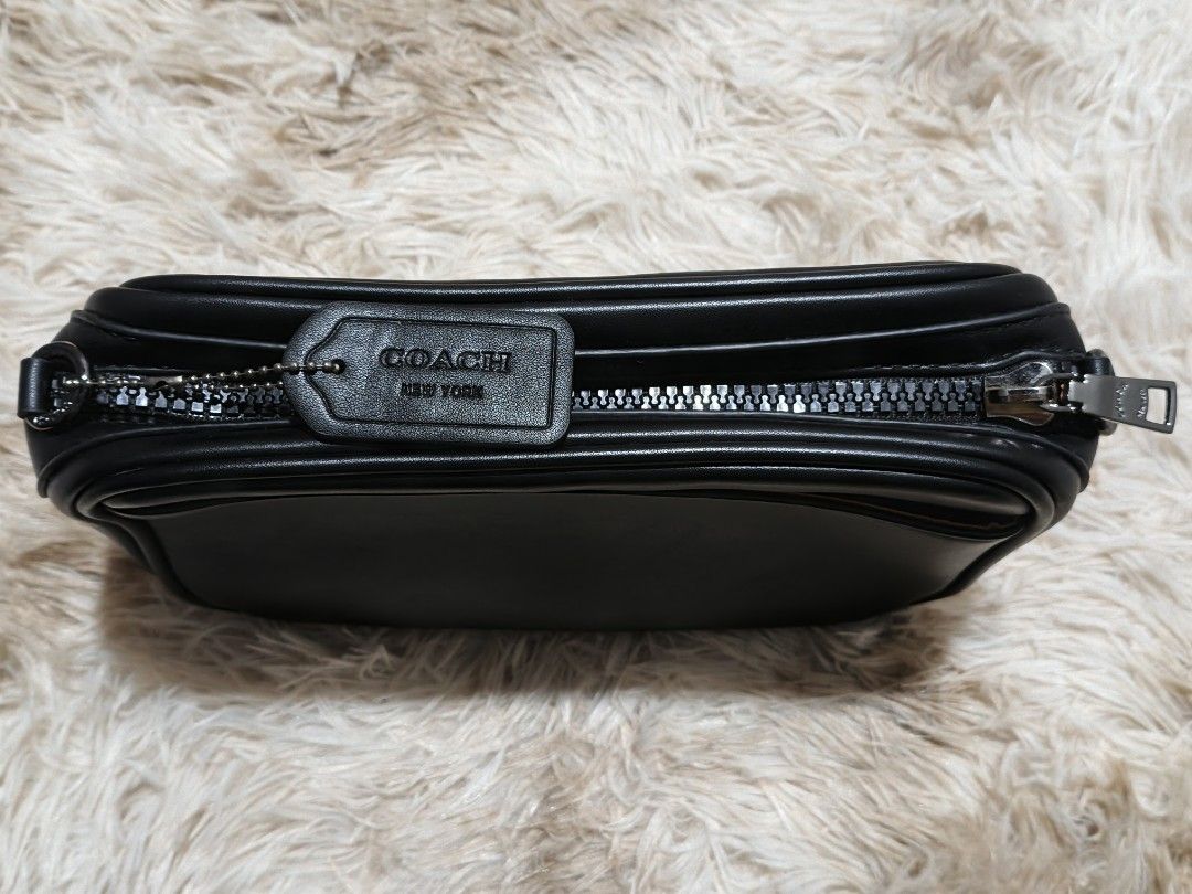 Coach Black Crossbody Bag (Category: Luxury Bags & Wallets) located in Makati City. Submitted by samantha_sofia_89 (Listing ID 1400763311, Image 2). Description: - Black Coach crossbody bag - Zip closure - Adjustable strap - Small front pocket - Light brown interior lining - Includes Coach tag - Silver-tone hardware - Coach logo on front and strap.