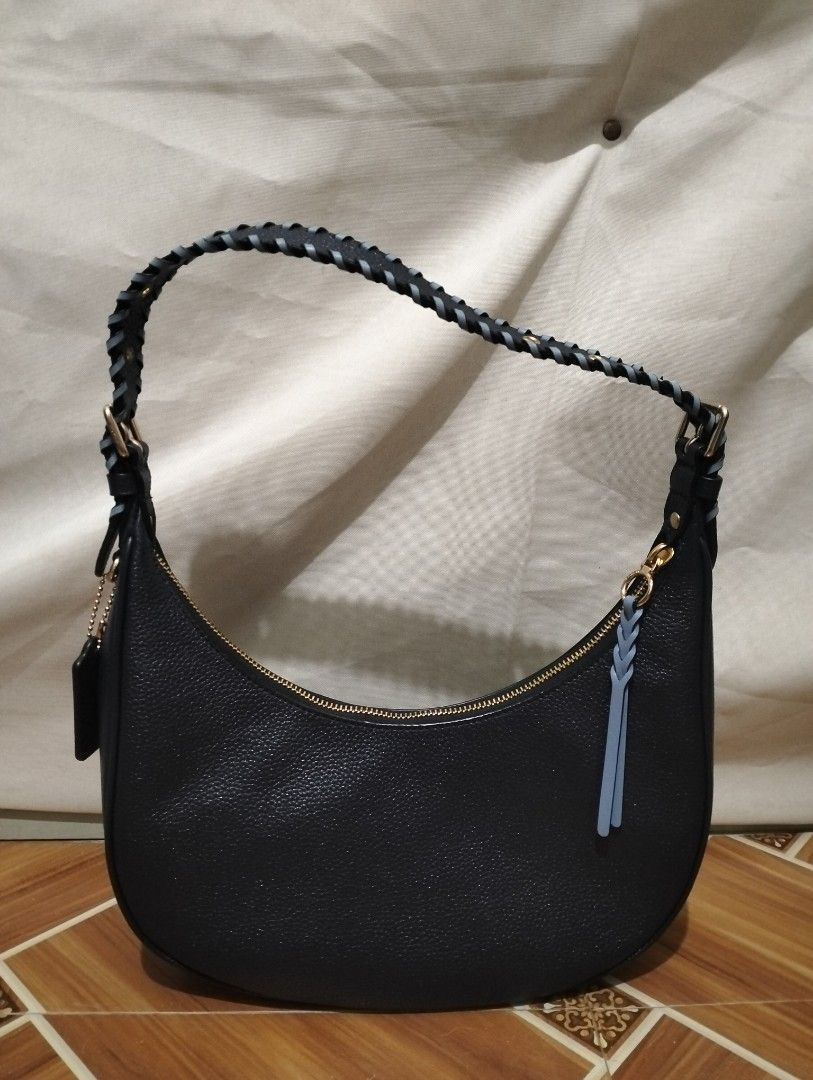 UNTAG - Coach Navy Blue Crescent Shoulder Bag (Category: Luxury Bags & Wallets) located in Manila. Submitted by mysticdolphin-fd4a (Listing ID 1400603682, Image 2). Description: Note: This is an UNTAG Original Couch Bag. SALE!SALE! Need to declutter na po! LAST PRICE!! - 700 - Original price - 1800 - From Cambodia - Navy Blue Coach shoulder bag - Crescent shape - Braided handle - Gold-tone hardware - Includes leather tag - Interior pocket - Zip c