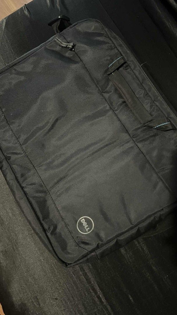 Dell Laptop Bag with Shoulder Strap (Category: Laptop Bags & Sleeves) located in Quezon City. Submitted by seeeen (Listing ID 1400643931, Image 1). Description: - Sleek black Dell laptop bag - Includes a comfortable shoulder strap - Features a convenient front pocket - Secure zipper closure - Designed to protect your laptop - Additional handle for carrying RFS: not used.